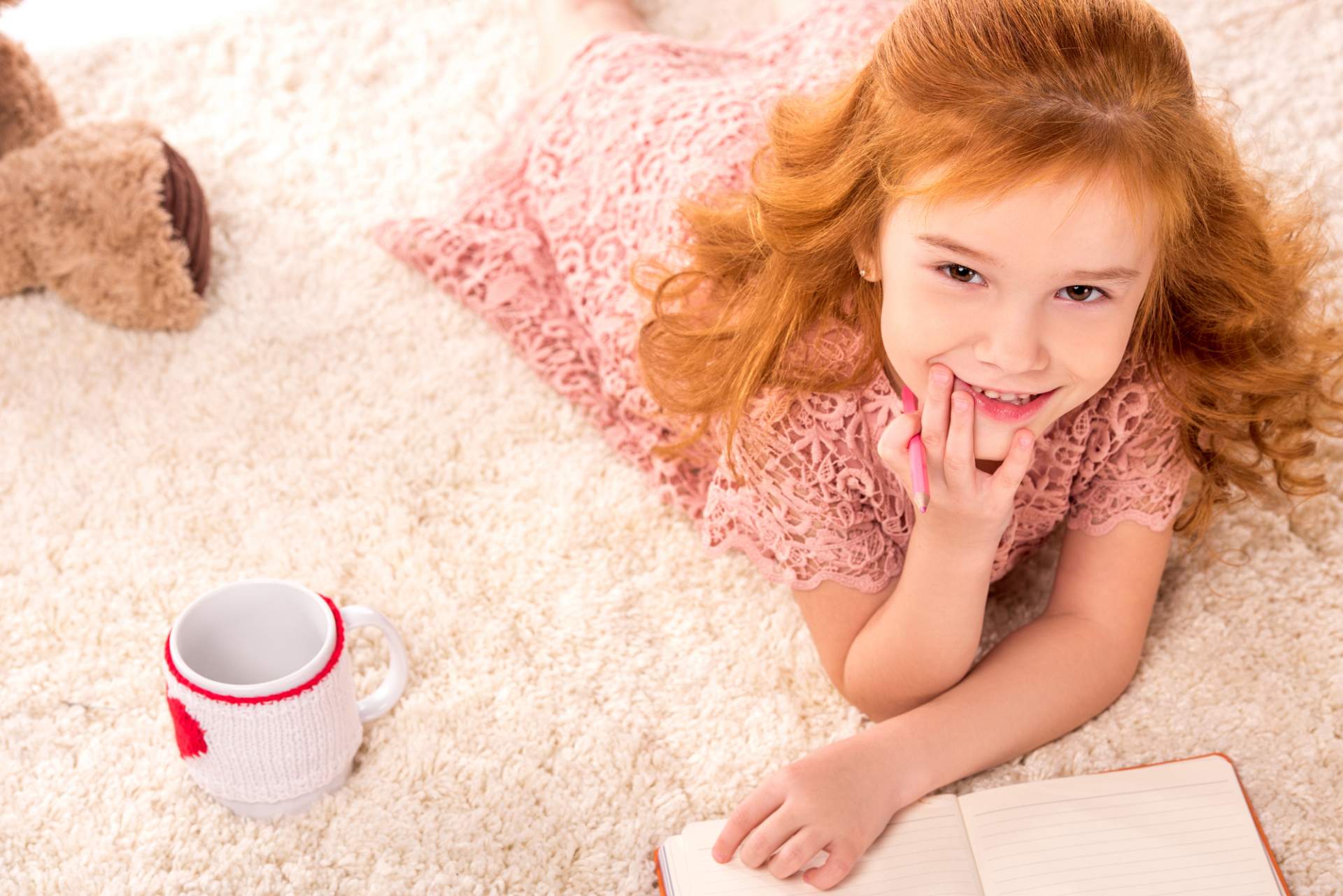 Young lady laying on clean white carpet